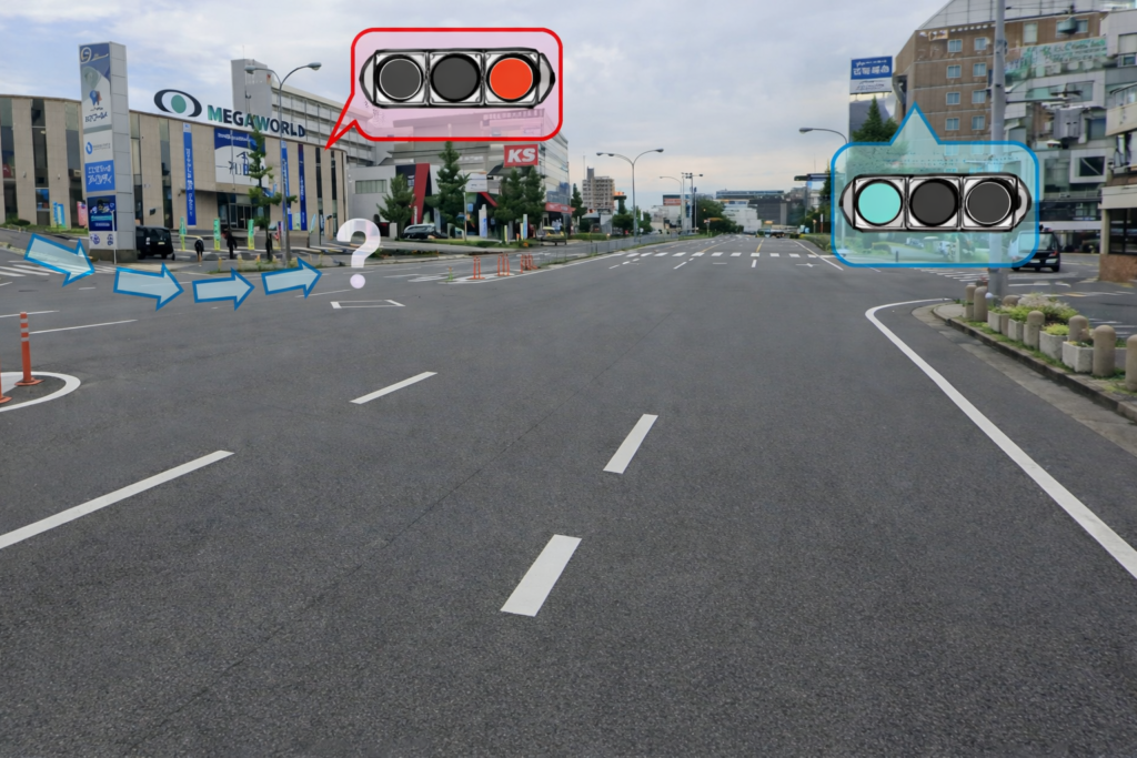 前方の信号に従い、青矢印のように左折すると、少し離れた前方に交差道路の赤信号が見える、名古屋市名東区高社2丁目の信号交差点